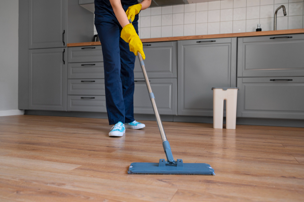 Janitor mopping kitchen floor in breakroom