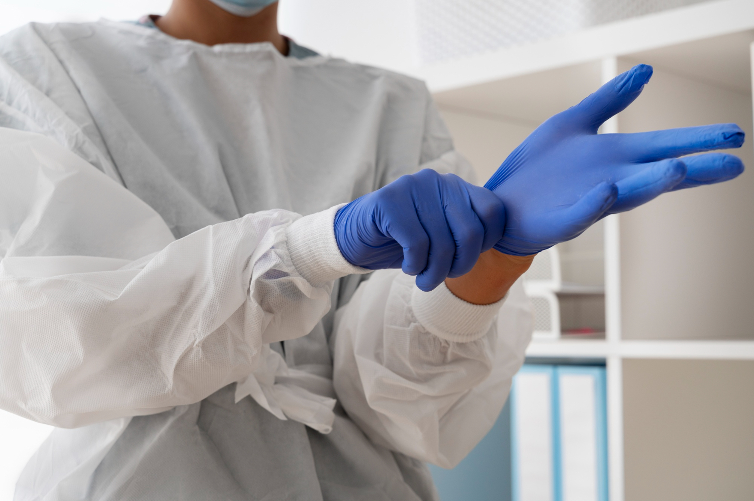 Gabriel's Cleaning team member putting gloves on at a medical office in Fresno